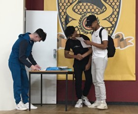 Harvey Macphee and twin brothers  Ahtisham Hyder and  Solomon Hyder in the blue cap opening their results